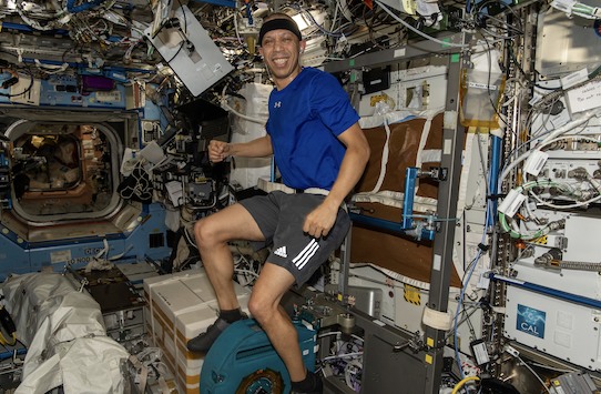 NASA astronaut Chris Williams pedals on the exercise cycle inside the International Space Station’s Destiny laboratory module.