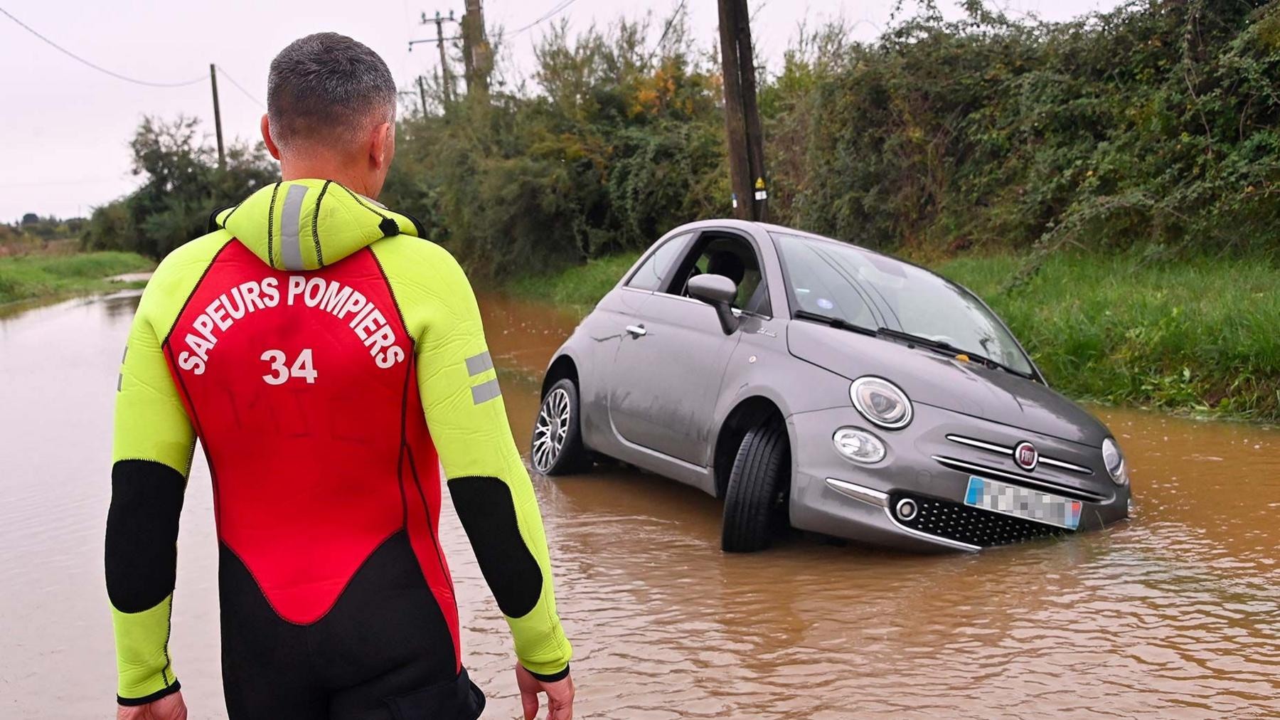 A firefighter checks a car in Lunel, near Montpellier.